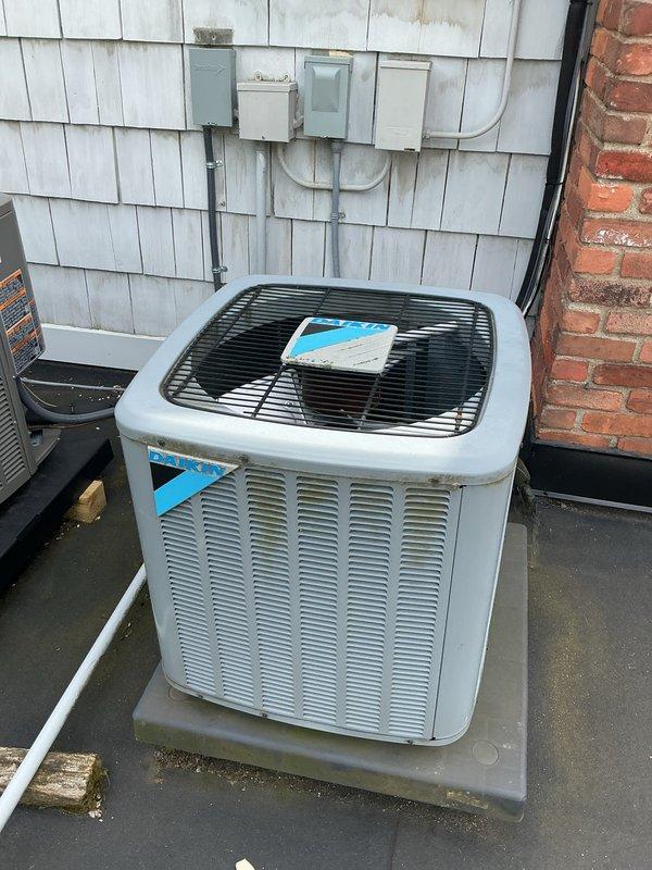 Completed comprehensive Gold AC Inspection and tune-up on a 3-year-old Lennox air conditioning system installed in 2017. Performed full preventive maintenance protocol on the outdoor condenser unit, including cleaning of condenser coils, inspection of refrigerant levels, electrical connections, and compressor operation. Verified proper airflow through louvered vents and confirmed fan motor functionality. Inspected electrical disconnect box and associated conduit for proper installation and safety compliance. Checked condensate drain line routing and verified unit stability on composite pad. System operating within normal parameters with no issues identified. Unit shows evidence of recent maintenance with protective materials in place, indicating ongoing care. Rooftop installation assessed for proper drainage and potential impact from organic growth on surrounding membrane surface, though unit remains unaffected. All components tested and confirmed operational for upcoming cooling seaso