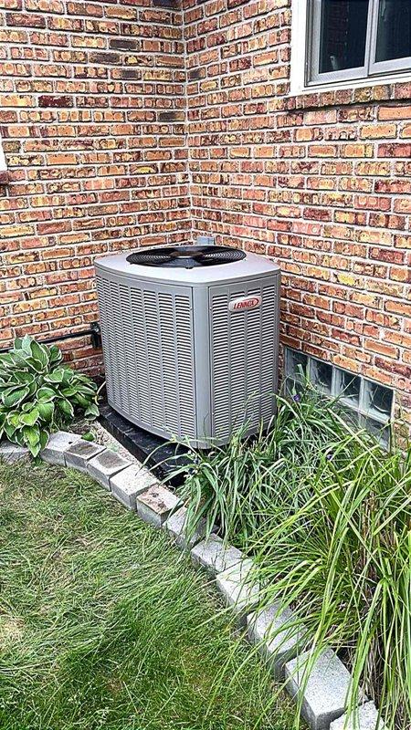 Completed installation of a 3-ton Lennox air conditioning unit with matching evaporator coil at rear of residence. Unit was positioned on concrete pad in corner location between brick walls, with all refrigerant lines reconnected and electrical service established. Mechanical and AC permits were secured prior to installation, and system was tested for proper operation upon completion.