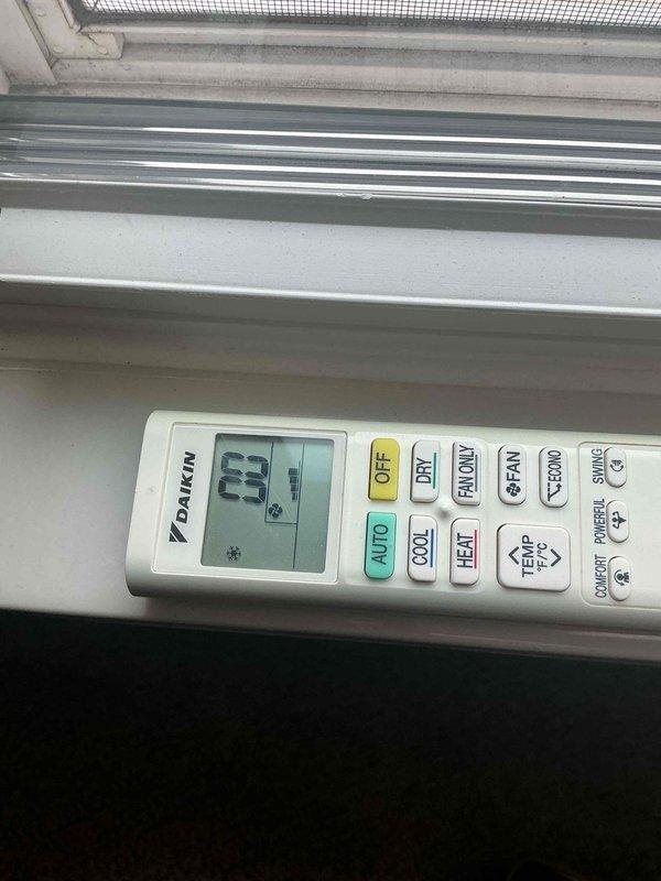 Responded to service call for 12-year-old Daikin mini-split system in upper bedroom with no heating or cooling function and clicking noise upon startup attempt. Upon arrival, conducted diagnostic assessment of both indoor head unit and outdoor condenser. Inspection revealed heavily corroded refrigerant line connections at outdoor unit with significant rust on brass fittings and deteriorated insulation on copper lines. Outdoor unit housing showed extensive weathering and debris accumulation on concrete pad. Performed system diagnostics using digital testing equipment to assess electrical and refrigerant system functionality. Documented existing conditions of remote control, refrigerant connections, and overall system deterioration for customer records and recommended repair options.