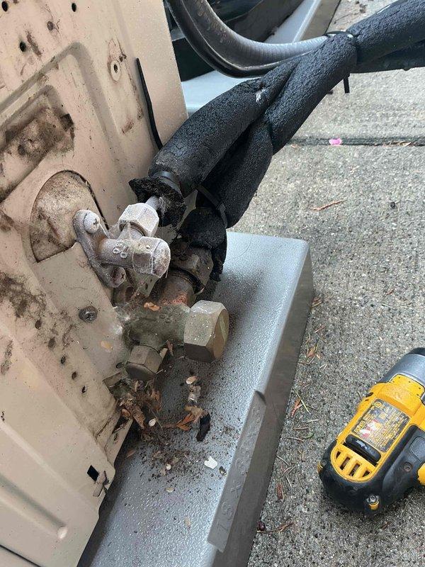 Responded to service call for 12-year-old Daikin mini-split system in upper bedroom with no heating or cooling function and clicking noise upon startup attempt. Upon arrival, conducted diagnostic assessment of both indoor head unit and outdoor condenser. Inspection revealed heavily corroded refrigerant line connections at outdoor unit with significant rust on brass fittings and deteriorated insulation on copper lines. Outdoor unit housing showed extensive weathering and debris accumulation on concrete pad. Performed system diagnostics using digital testing equipment to assess electrical and refrigerant system functionality. Documented existing conditions of remote control, refrigerant connections, and overall system deterioration for customer records and recommended repair options.
