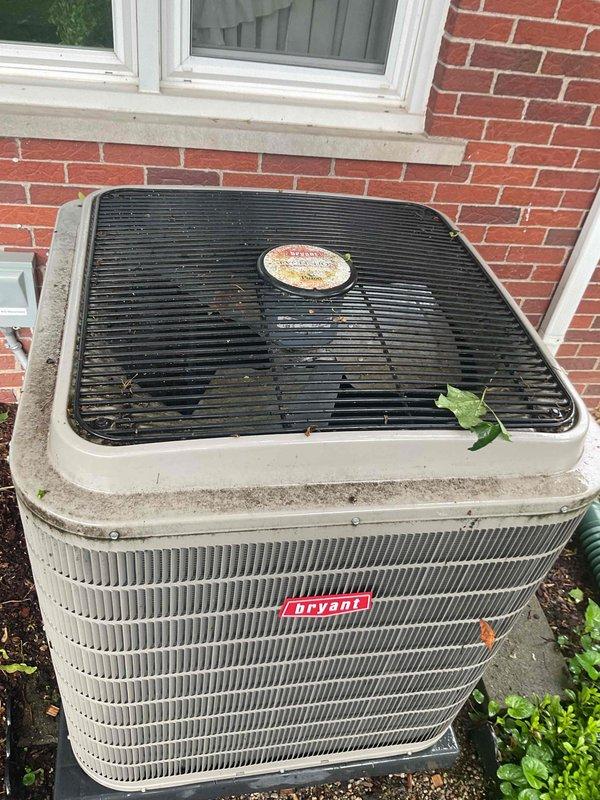Completed Gold AC Inspection on a 7-year-old Bryant air conditioning system. Performed comprehensive evaluation of outdoor condenser unit, which showed normal weathering consistent with age but remained in functional condition. Verified system operation, inspected heat exchanger coils and fins for proper airflow, checked refrigerant lines, and confirmed unit stability on concrete pad. Noted minor debris accumulation on top grille and surrounding area, typical for outdoor equipment. All components operating within normal parameters at time of inspection.