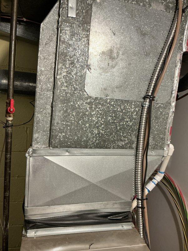 Conducted comprehensive HVAC replacement estimate for 20-year-old air conditioning system experiencing low refrigerant levels and inadequate cooling performance. Upon inspection of the basement-installed equipment, determined that repair costs would be prohibitively high given the age and condition of the existing system, with visible dust accumulation and wear on components. Provided detailed replacement options and specifications for new high-efficiency system to restore proper cooling capacity and improve overall system performance.