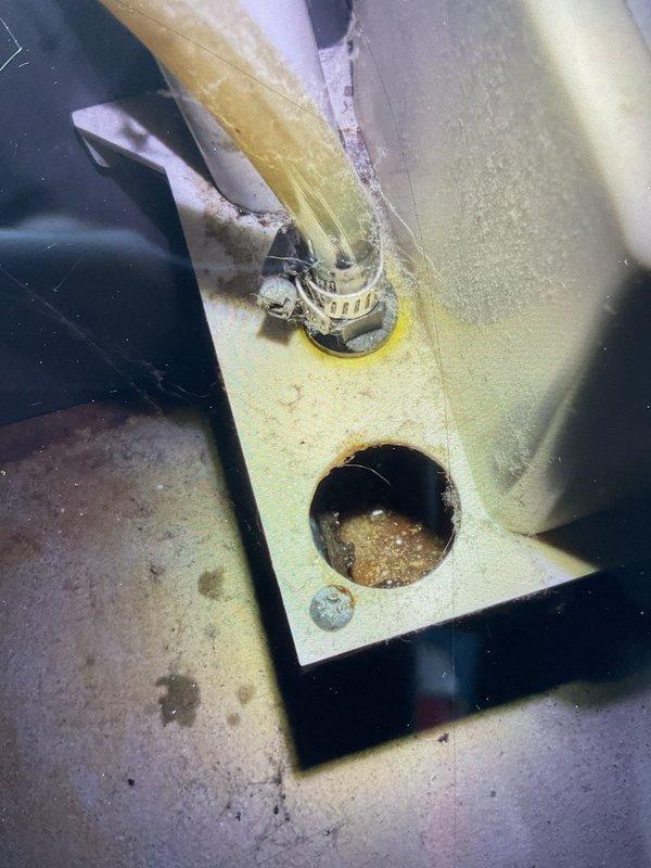 # Water Leak Investigation and System Assessment

Responded to reported water leak from 15-year-old furnace unit. Upon arrival, conducted thorough inspection of furnace and identified source of water intrusion. Examined condensate drain pan and drainage system components, noting significant accumulation of sediment, mineral deposits, and biological growth within drain pan. Observed brownish discoloration and debris buildup affecting proper drainage function.

Inspected drain pan condition and found evidence of long-term moisture exposure with visible staining on pan surface and surrounding areas. Examined drain fittings, connections, and condensate removal components. Documented deteriorated insulation material showing compression and moisture damage. Assessed drain line routing and connectivity to ensure proper pitch and flow.

Per request, performed comprehensive evaluation of entire HVAC system including visual inspection of all accessible components. Examined furnace heat exchanger