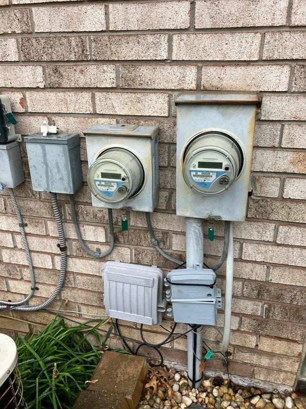 Responded to service call for air conditioning system blowing warm air. Upon inspection, diagnosed compressor failure on 1991 AC unit located in basement. Provided comprehensive replacement estimate for new air conditioning system. Documented existing outdoor condensing unit with protective cage mounted on concrete pad, electrical metering configuration, and overall installation setup through photographic documentation to support replacement recommendations.