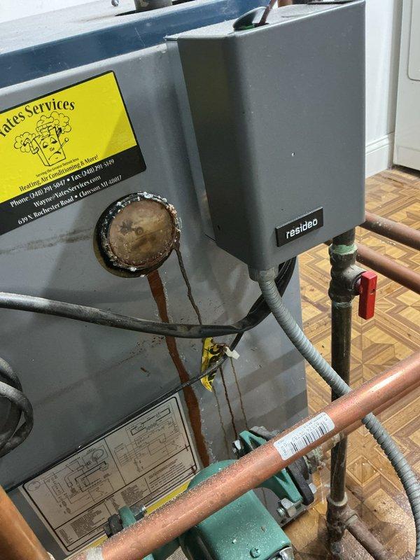 Responded to service call for 15-year-old residential boiler system located in basement. Upon arrival, performed comprehensive system inspection and diagnostic evaluation of boiler unit, associated copper piping, circulation components, and control systems. Identified temperature pressure sensor issue requiring replacement, with part ordered under purchase order for installation. Inspected Resideo control panel, verified electrical connections, and examined all plumbing connections including shut-off valves and pressure monitoring devices. Evaluated flue pipe assembly and ventilation components for proper operation. Documented system condition through photographic records showing boiler unit, piping configuration, circulation pump, and control components. System remained operational throughout service visit, continuing to provide heat while awaiting sensor replacement to resolve reported issue and restore full functionality.