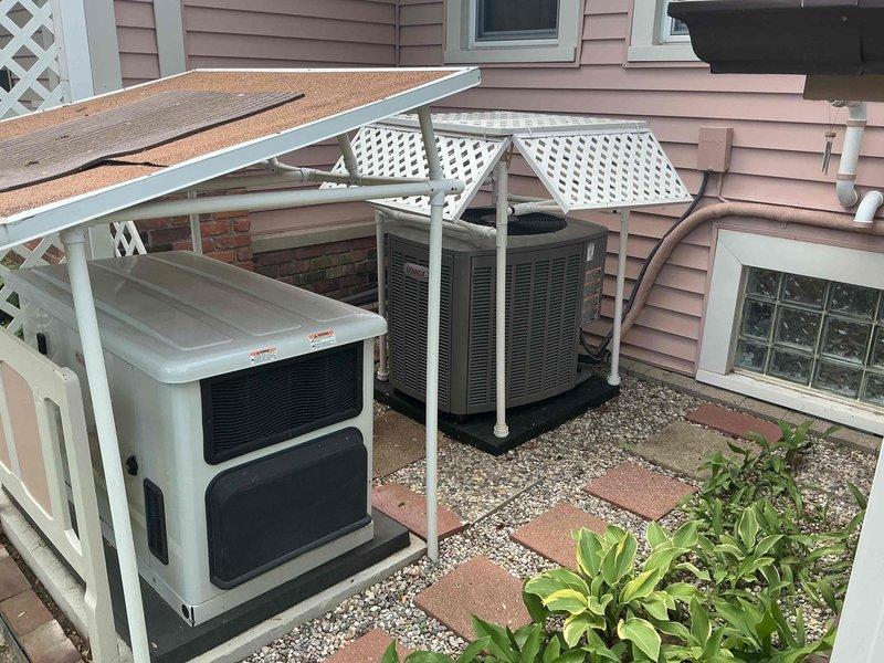 Responded to no-start condition on residential AC unit less than one year old. Diagnosed electrical issue traced to incorrect fuse specification. Verified correct replacement fuse available at supply house under existing purchase order. Dual outdoor condensing units installed on gravel pad beneath latticed pergola structure with indoor coil located in basement. System under manufacturer warranty coverage.