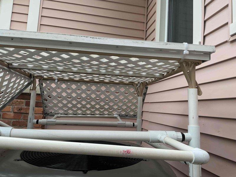 Responded to no-start condition on residential AC unit less than one year old. Diagnosed electrical issue traced to incorrect fuse specification. Verified correct replacement fuse available at supply house under existing purchase order. Dual outdoor condensing units installed on gravel pad beneath latticed pergola structure with indoor coil located in basement. System under manufacturer warranty coverage.