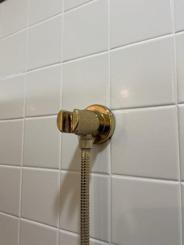Responded to service call for multiple plumbing repairs. Replaced broken under-sink mounting bracket to secure vanity basin and restore structural support. Removed existing shower head and installed new handheld shower fixture with flexible stainless steel hose and wall-mounted holder bracket on tiled shower wall. Inspected toilet tank assembly and adjusted flapper chain length to ensure proper seating and seal, eliminating continuous running water and preventing tank overflow condition. Tested all repairs for proper operation and verified no leaks present at connections.