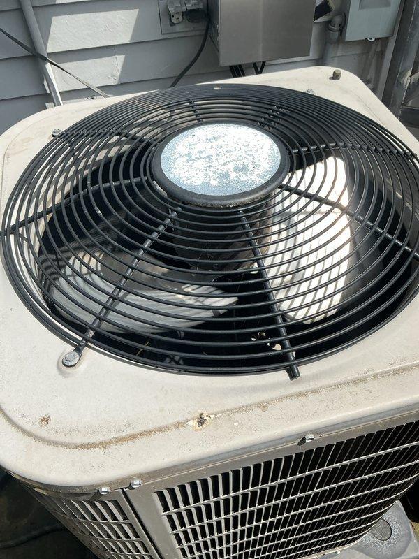 Completed comprehensive Gold AC inspection on residential cooling system with air handler located in basement and condenser unit positioned on rooftop. Performed thorough visual assessment of outdoor condenser unit, noting weathered housing with age-related discoloration but no severe damage or deterioration, and inspected heat exchanger coils which displayed normal operational condition with protective cage showing rust and corrosion on metal framework. Advised customer that area surrounding condenser requires clearing of debris and animal waste to maintain proper airflow and system efficiency.