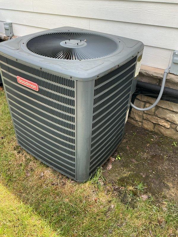 Completed comprehensive Gold AC inspection on two Goodman condenser units, both approximately 5 years old, with air handlers located in attic and basement. Performed full system evaluation including visual inspection of exterior cabinets, condenser coils, fan operation, electrical connections, and refrigerant lines on both units. Both systems confirmed operational with no immediate service needs identified; minor debris accumulation noted at base of units with recommendations provided for maintaining adequate clearance around equipment.