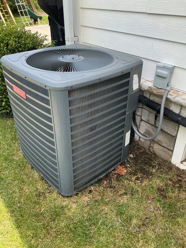 Completed comprehensive Gold AC inspection on two Goodman condenser units, both approximately 5 years old, with air handlers located in attic and basement. Performed full system evaluation including visual inspection of exterior cabinets, condenser coils, fan operation, electrical connections, and refrigerant lines on both units. Both systems confirmed operational with no immediate service needs identified; minor debris accumulation noted at base of units with recommendations provided for maintaining adequate clearance around equipment.