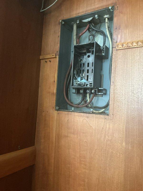 Responded to emergency service call for sparking electrical panel. Upon arrival, confirmed power had been shut off as a safety precaution. Inspected main electrical panel and fuse box assembly, identifying deteriorated connections and potential arcing at circuit breaker terminals. Found outdated fuse-style panel with compromised wiring connections causing electrical arcing. Evaluated panel condition, noting multiple colored wires (black, red, white) with signs of heat damage near connection points. Documented existing Cutler-Hammer service control equipment and circular fuse configuration in garage panel. Secured all loose connections, cleaned oxidation from contact points, and verified proper wire gauge and termination integrity throughout the panel assembly. Tested restored power supply under load to ensure safe operation without further arcing or sparking. Recommended panel upgrade to modern circuit breaker system to prevent future safety hazards.