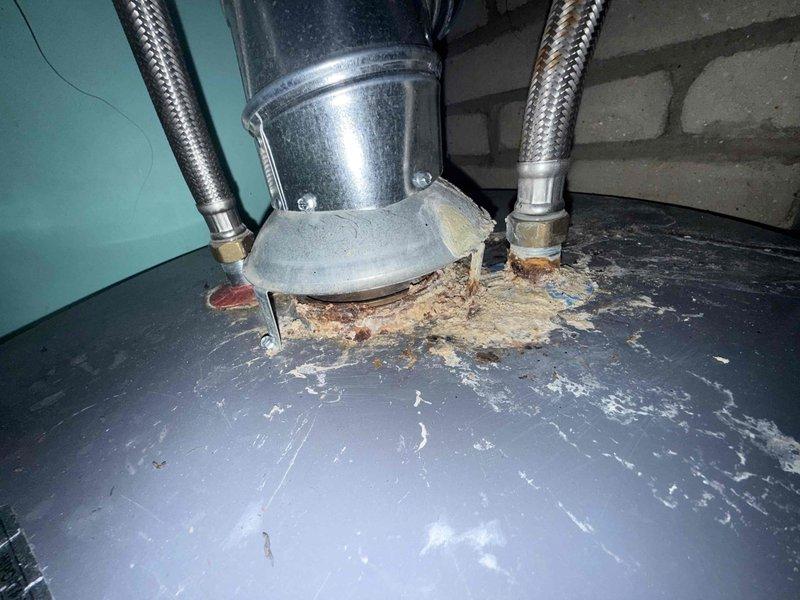 Responded to no cooling complaint on 30-year-old air conditioning system located in basement. Upon inspection, found compressor failing to engage properly, preventing refrigerant circulation and cooling capacity. Observed deteriorated electrical components with significant corrosion on mounting surfaces and control panel housing, indicating extended service life and environmental wear. Capacitor showed age-related degradation with visible rust staining on surrounding metal surfaces. Examined condensate drain connections and found accumulated debris around base assembly. System exhibited multiple signs of end-of-life condition including worn wiring connections, mineral deposits, and compromised structural integrity of cabinet components. Documented equipment condition with photographs showing corroded mounting brackets, deteriorated paint surfaces, and sediment accumulation. Due to age of equipment and extent of component failure, recommended complete system replacement rather than repa