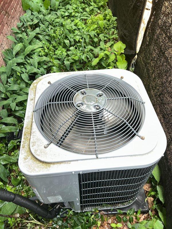 Completed comprehensive Gold AC inspection on 10+ year old residential air conditioning system. Inspected outdoor condenser unit, confirmed proper operation of compressor and fan motor, examined heat exchanger coils showing normal age-related weathering, and verified refrigerant lines and connections at exterior unit. Equipment is functioning properly with no immediate service needs identified; documented system condition with photos for maintenance records.