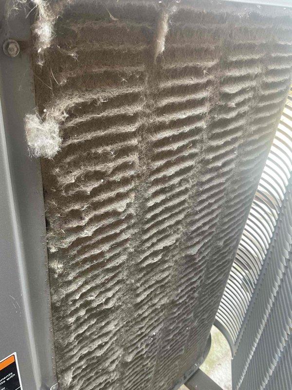 Responded to no-cool call for rooftop commercial AC unit. Upon arrival, found outdoor condensing unit with heavily restricted airflow due to excessive dirt, dust, and lint accumulation on condenser coil fins. Unit age confirmed at 10+ years with R-22 refrigerant system. Documented equipment condition showing significant debris buildup compromising heat transfer efficiency. Advised customer of required condenser coil cleaning and comprehensive system evaluation to address cooling failure and reported refrigerant leak.