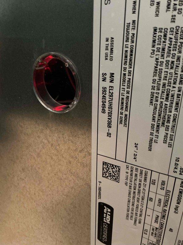 Responded to service call for an Ecobee thermostat that had gone blank with no display and lost access to heating and cooling system control. Upon arrival, removed the thermostat from the wall mount to inspect the unit and verify model information and manufacturing details. The 2-year-old unit showed no signs of power, indicating either a wiring issue, C-wire power supply problem, or internal component failure. Documented the thermostat's underside specifications and certification markings for warranty verification and potential replacement purposes.