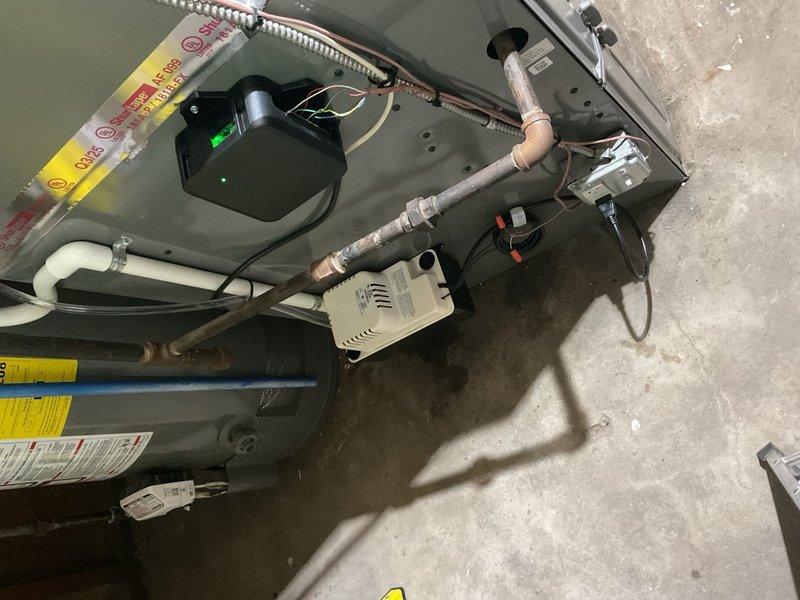 Completed installation of 1.5 ton air conditioning system with evaporator coil in residential utility space. Installed new air handler unit, connected refrigerant lines with proper insulation, established condensate drainage via PVC piping, and integrated ductwork with existing distribution system. Electrical reconnection required by licensed electrician to finalize system commissioning per permit requirements.