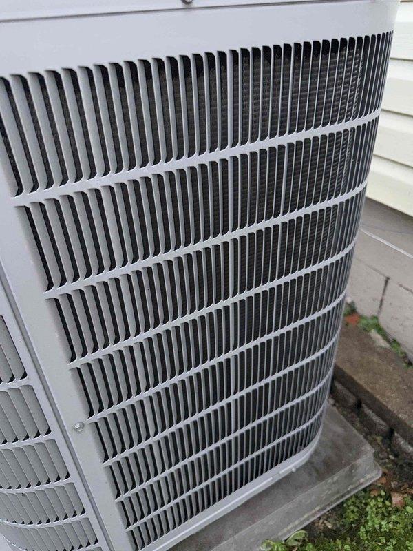 Completed comprehensive Gold AC inspection on 10+ year old single-unit air conditioning system with outdoor condenser and basement-located air handler. System was operational at time of service. Performed thorough visual inspection of outdoor condenser unit, verifying proper clearance from structure, secure mounting on concrete pad, and structural integrity of cabinet and protective grilles. Examined condenser coil fins for alignment, cleanliness, and airflow obstruction—coils appeared clean with properly aligned fins and no visible damage or deterioration. Inspected exterior housing for rust, corrosion, or weather damage; unit showed typical outdoor weathering with no significant concerns. Verified manufacturer labeling was intact and legible. Assessed overall equipment condition and confirmed unit remains in serviceable condition with no immediate repairs required. System continues to operate as designed.