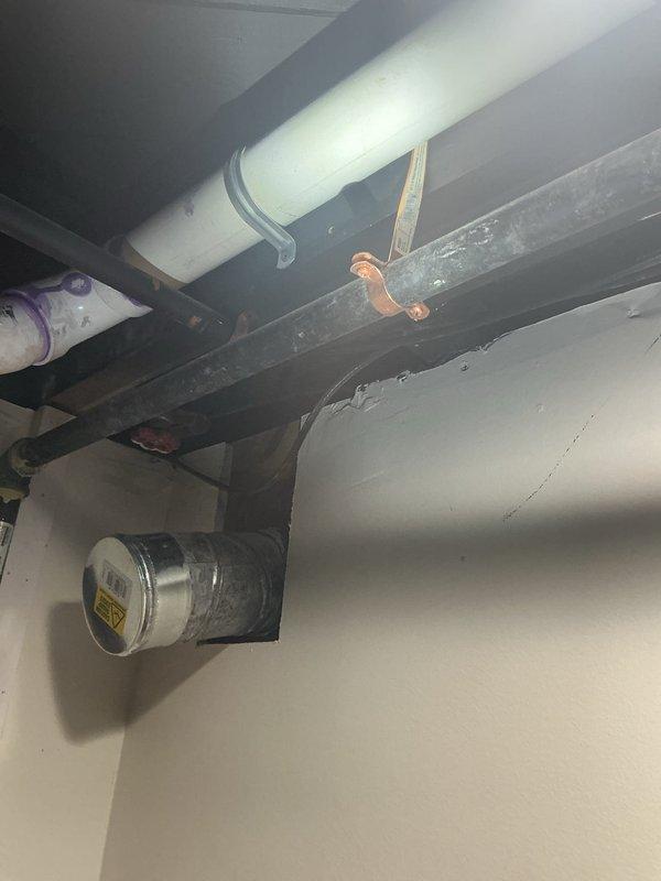 Completed comprehensive whole home plumbing inspection with particular emphasis on the tankless water heater system. Inspection revealed a professionally installed wall-mounted tankless unit with proper PVC exhaust venting, copper water supply lines, corrugated stainless steel gas line (CSST), and expansion tank. Verified all connections, mounting brackets, and support systems throughout the basement utility area including overhead PVC drainage lines, copper piping, and HVAC ductwork. Documented the condition of all plumbing infrastructure, pipe supports, and mechanical systems. All components were photographed for record-keeping purposes, with special attention given to the water heater installation as requested.