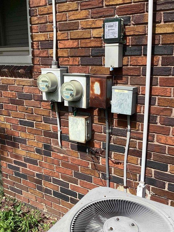 Conducted comprehensive evaluation of existing HVAC system at residential property for replacement estimate. Inspected outdoor condensing unit located at exterior brick wall alongside electrical meter assembly and assessed indoor air handler unit installed in attic space with associated ductwork and condensate drainage system. Documented current system configuration, equipment condition, and installation specifications to provide accurate replacement recommendations for complete heating and cooling system.