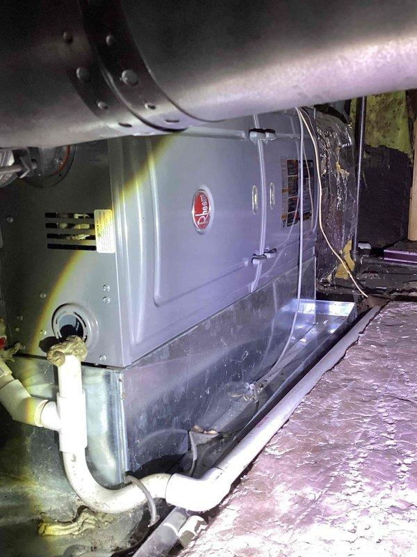 Conducted comprehensive evaluation of existing HVAC system at residential property for replacement estimate. Inspected outdoor condensing unit located at exterior brick wall alongside electrical meter assembly and assessed indoor air handler unit installed in attic space with associated ductwork and condensate drainage system. Documented current system configuration, equipment condition, and installation specifications to provide accurate replacement recommendations for complete heating and cooling system.