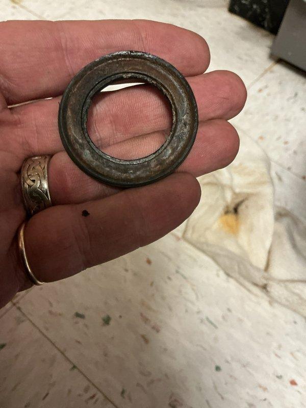 Responded to water leak complaint on 12-year-old hot water boiler located in basement. Upon inspection, identified failed gasket at brass pipe fitting connection causing active leak. Removed deteriorated gasket from hexagonal nut connector, replaced with new gasket, and reassembled plumbing connection. Tested system under pressure to confirm leak was resolved and all connections were secure.