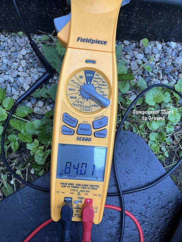 Responded to no cooling complaint on residential air conditioning system installed in February 2026. Upon arrival, confirmed thermostat was calling for cooling and indoor blower was operating, but outdoor condensing unit was not running. Performed electrical diagnostics at outdoor unit using digital multimeter to test compressor windings and electrical components.

Testing revealed compressor failure with abnormal resistance reading of 840 ohms from start winding to ground, indicating internal winding short to compressor housing. Verified power supply at disconnect switch and confirmed all safety controls were functioning properly. Determined compressor had failed internally despite unit being under one year old and having completed spring startup service in April 2026.

Recommended and received approval for compressor replacement under warranty coverage. Removed failed compressor from system for further diagnostic evaluation at shop. Secured disconnect switch in OFF position and infor
