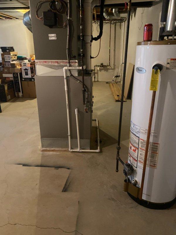Completed installation of a 4-ton air conditioning system with matching evaporator coil in basement mechanical room, positioned on right side of existing utility area. Unit installed per manufacturer specifications using R-454B refrigerant, with all condensate lines, refrigerant lines, and ductwork connections completed. Electrical reconnection work noted as requiring licensed electrician for final power connection, and mechanical permit has been requested for inspection compliance.