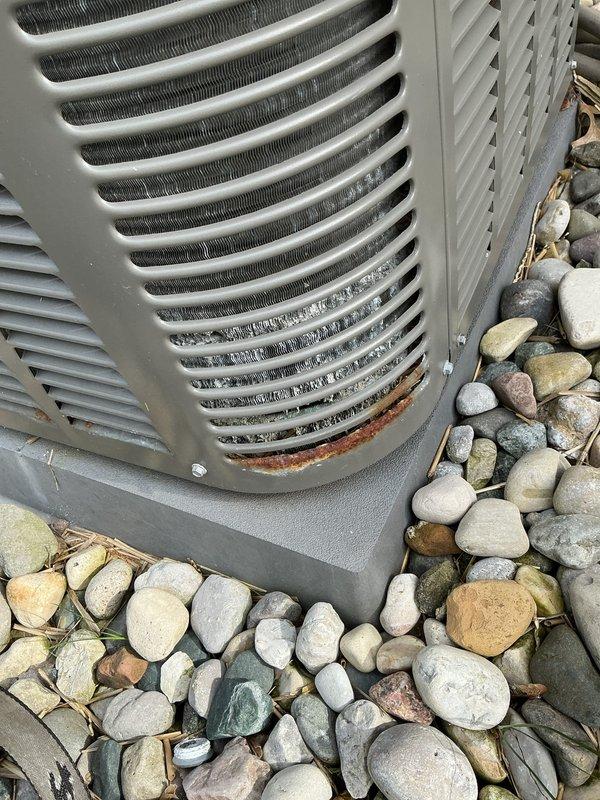 Completed comprehensive Gold AC Inspection on 13-year-old Lennox air conditioning system with air handler located in basement. Performed full system evaluation including refrigerant pressures, electrical connections, condenser coil inspection, and operational testing. Noted exterior corrosion and rust on lower front panel of outdoor condenser unit requiring monitoring for potential future panel replacement to prevent further deterioration.