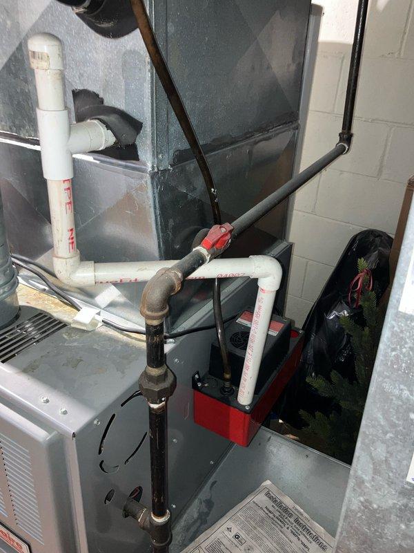 Responded to service call for approximately 30-year-old Janitrol R22 central air conditioning system experiencing loud metal screeching and hub vibration after three minutes of outdoor fan motor operation. Diagnosed failed outdoor fan motor with seized bearings preventing motor shaft separation. Provided replacement estimate for complete system due to age of equipment, R22 refrigerant phase-out, and repair costs approaching replacement value.