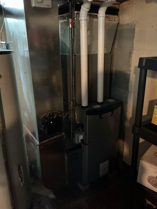 Completed general preventative AC inspection on residential split system less than one year old. Inspected indoor evaporator coil located in basement mechanical room and outdoor condensing unit positioned on pad against exterior brick wall. Verified proper operation of furnace/air handler, checked refrigerant line connections, confirmed condensate drain lines are clear and functioning, and inspected electrical connections at both indoor and outdoor units. All components found to be in good working order with no immediate service needs identified. System operating within normal parameters for equipment of this age.