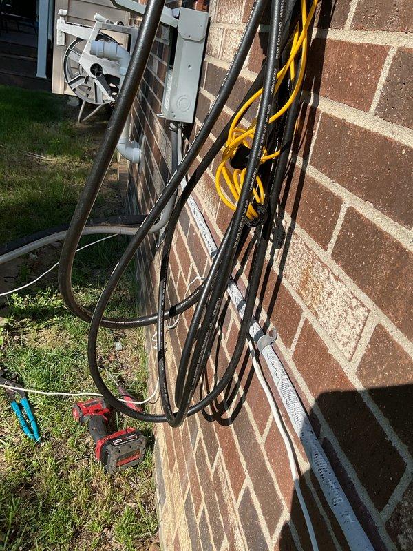 Completed installation of a 3.5-ton air conditioning unit with matching evaporator coil in the rear yard location. System was professionally mounted on brick exterior, all electrical connections and refrigerant lines were properly installed and secured with appropriate conduit and cable management, and unit was successfully reconnected and tested for proper operation.