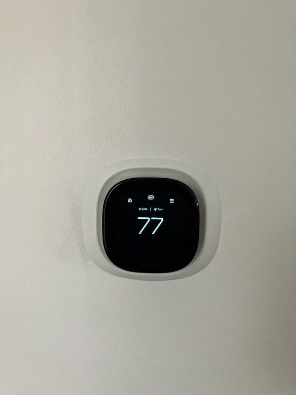 Completed furnace replacement estimate for 26-year-old Luxaire heating system located in basement. Assessed existing equipment including furnace unit with flexible metallic ductwork connections and adjacent gray metal air handler with plenum assembly. Evaluated smart thermostat compatibility and provided comprehensive replacement quote for aging HVAC system.