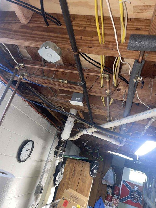 Completed on-site assessment for heating system replacement estimate. Evaluated existing 10-year-old furnace located in basement with exposed ceiling joists and existing ductwork infrastructure. Documented current HVAC equipment including exterior condensing unit and interior mechanical systems, photographed installation area and accessibility for future replacement work.