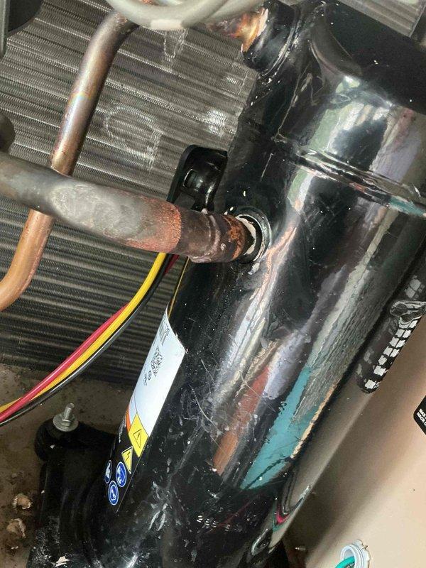 Responded to no cooling complaint on commercial rooftop unit. Upon inspection, found compressor with significant corrosion on copper refrigerant lines and turquoise staining on housing indicating chemical breakdown or refrigerant leak. Compressor exhibited visible wear and oxidation at connection points. Removed failed compressor from unit and transported to shop for warranty processing with Garrin. Unit requires compressor replacement under warranty to restore cooling operation.