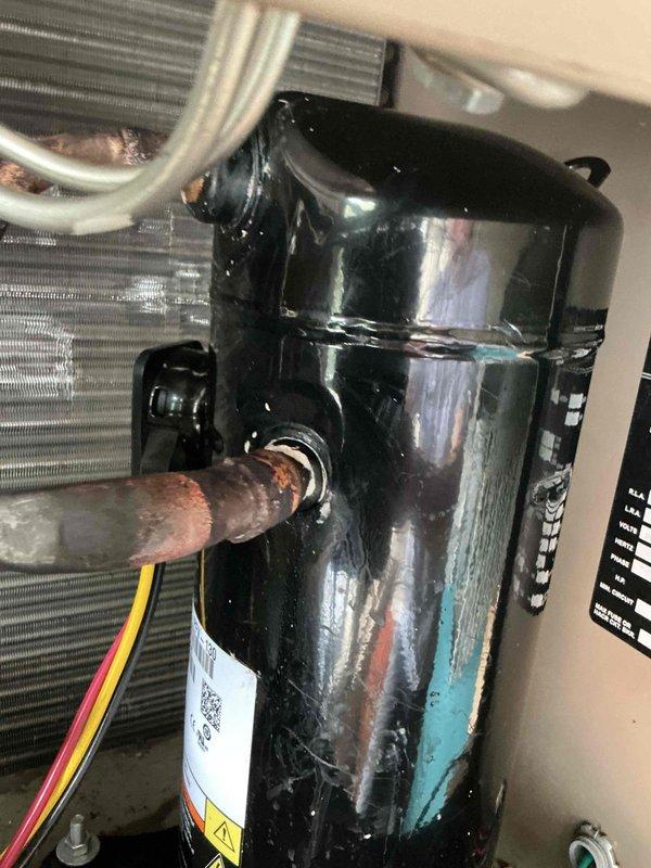 Responded to no cooling complaint on commercial rooftop unit. Upon inspection, found compressor with significant corrosion on copper refrigerant lines and turquoise staining on housing indicating chemical breakdown or refrigerant leak. Compressor exhibited visible wear and oxidation at connection points. Removed failed compressor from unit and transported to shop for warranty processing with Garrin. Unit requires compressor replacement under warranty to restore cooling operation.