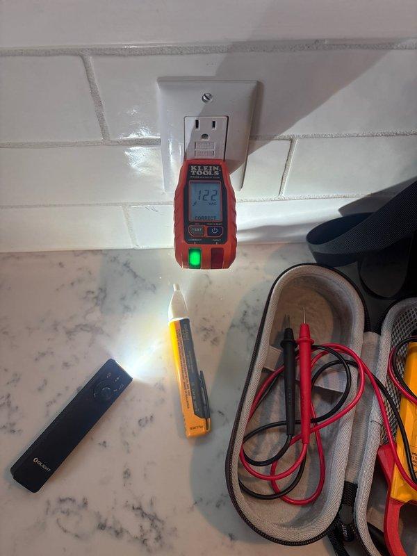 Responded to service call for multiple non-functioning outlets throughout the residence. Upon arrival, performed systematic electrical testing using digital voltage meter at affected outlet locations, including kitchen area with marble countertop and secondary location with horizontal panel siding. Testing revealed voltage irregularities, with readings of 122V and 102V respectively at different circuits. Diagnosed and resolved the electrical issue, restoring proper power to all affected outlets in the home.