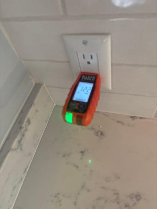 Responded to service call for multiple non-functioning outlets throughout the residence. Upon arrival, performed systematic electrical testing using digital voltage meter at affected outlet locations, including kitchen area with marble countertop and secondary location with horizontal panel siding. Testing revealed voltage irregularities, with readings of 122V and 102V respectively at different circuits. Diagnosed and resolved the electrical issue, restoring proper power to all affected outlets in the home.