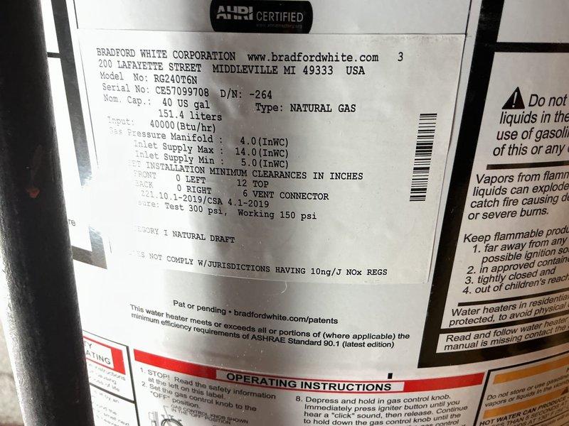 Installed a 40-gallon Bradford White natural gas water heater (Model RG240T6N) with 40,000 BTU/hr input capacity in basement utility space. Installation included drip pan with alarm system and reconnection of all gas, water, and venting components per manufacturer specifications and ASHRAE Standard 90.1 compliance requirements.