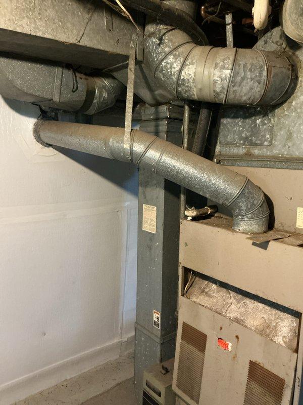 Conducted on-site assessment for complete HVAC system replacement in a small residential property under 1500 square feet. Evaluated existing furnace and air conditioning equipment located in basement utility area, noting aged ductwork with metallic insulation and current beige-colored HVAC unit. Inspected electrical service panel and circuit breaker configuration to ensure adequate power supply capacity for new heating and cooling equipment installation. Documented existing system layout, ductwork conditions, and electrical infrastructure to prepare comprehensive replacement estimate for natural gas furnace and central air conditioning system.