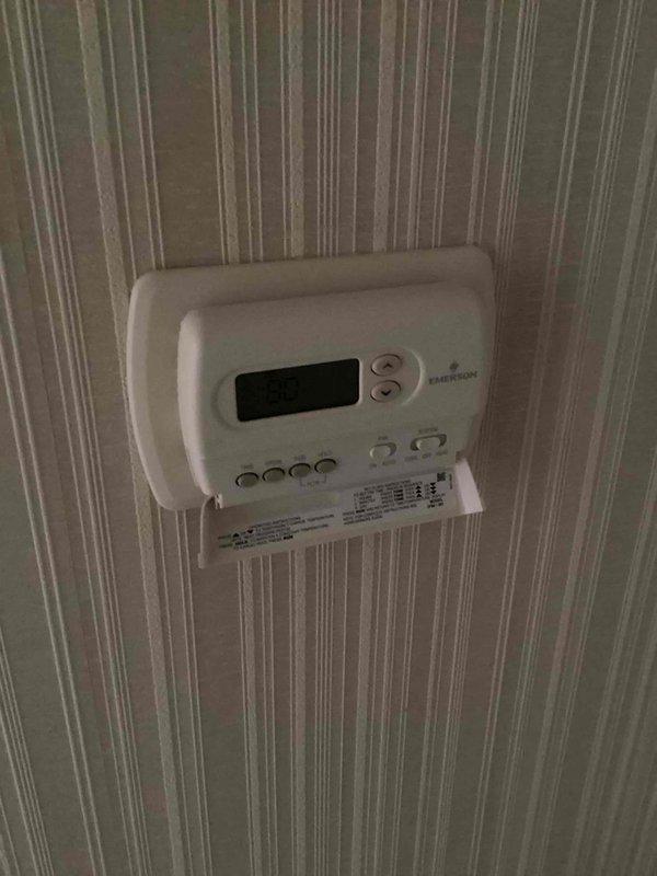 Conducted comprehensive evaluation of residential HVAC system for replacement estimate. System consists of outdoor condensing unit and basement-located air handler/coil assembly, both exceeding 10 years of service life. Documented existing Emerson digital thermostat and outdoor cylindrical condenser unit configuration. Assessed equipment condition, operational status, and site preparation requirements including utility markings present on property. Provided detailed replacement recommendations and equipment specifications for complete system upgrade.