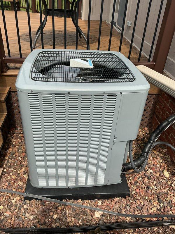 Completed comprehensive Gold AC Inspection on residential split system with outdoor condenser unit installed in 2023 and furnace located in basement. Performed thorough visual inspection of exterior condenser unit, verified proper installation on pad with adequate clearance, checked refrigerant lines and electrical connections, and documented equipment condition through photographs. Unit found to be in good operating condition with no visible deficiencies noted.