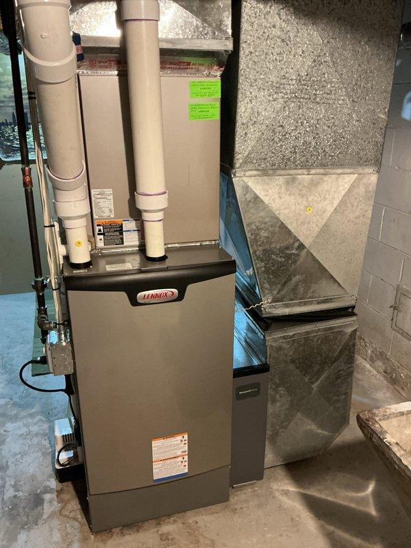 Completed comprehensive Gold AC inspection on 2-year-old Lennox HVAC system with air handler located in basement. Verified operational status of single-unit residential system, inspected furnace unit, ductwork, and plenum insulation for proper installation and condition. Confirmed thermostat functionality with Honeywell Home digital unit displaying proper temperature reading of 73°F. All equipment operating within normal parameters with no deficiencies noted during inspection.