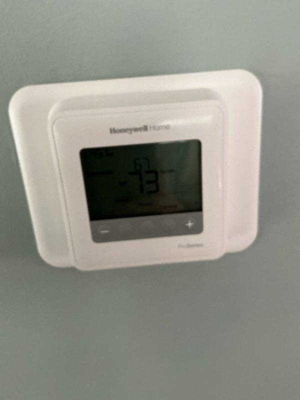Completed comprehensive Gold AC inspection on 2-year-old Lennox HVAC system with air handler located in basement. Verified operational status of single-unit residential system, inspected furnace unit, ductwork, and plenum insulation for proper installation and condition. Confirmed thermostat functionality with Honeywell Home digital unit displaying proper temperature reading of 73°F. All equipment operating within normal parameters with no deficiencies noted during inspection.