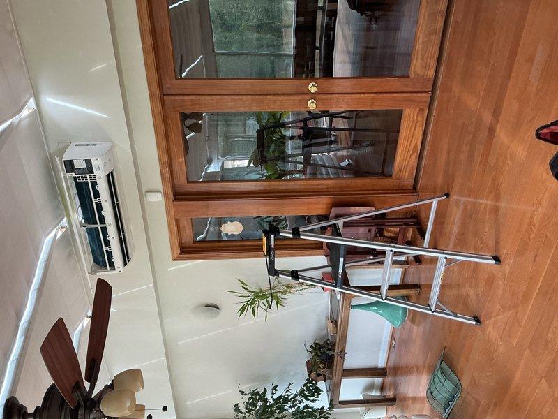 Returned to perform leak search on Daikin mini split heat pump system in sunroom that was not heating. Coordinated with technical support to diagnose ongoing system failure. Service valves required for repair remain on backorder from factory and will be available at Williams Southfield under PO 1305460-001. Documented unit condition with photos showing wall-mounted indoor air handler installation. System originally installed December 2020 and requires follow-up once replacement parts arrive to complete repair and restore heating functionality.