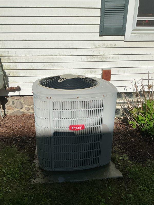 Completed Gold AC Inspection on 10+ year old Bryant air conditioning system with air handler located in basement. Performed comprehensive visual inspection of outdoor condensing unit positioned on concrete pad. Examined electrical contactor assembly, noting accumulated dirt and debris consistent with equipment age. Inspected contactor terminals, mechanical linkages, and wiring connections for proper operation and integrity. Evaluated outdoor unit condition including protective grille, manufacturer labeling, and overall cabinet weathering. Assessed installation site including concrete pad stability and surrounding landscaping clearances. Documented equipment condition through photographic records. Unit confirmed operational at time of inspection. All inspection items completed per Gold maintenance protocol specifications.