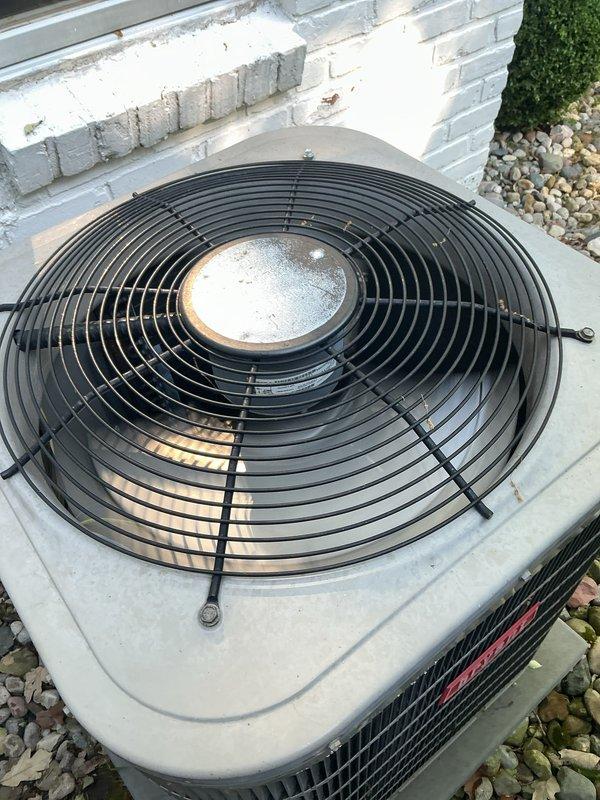 Completed comprehensive Gold AC inspection on 10+ year old residential air conditioning system with air handler located in basement. Outdoor condenser unit found operational with functional fan assembly and motor, though showing age-appropriate weathering and surface dirt accumulation. Advised customer to maintain clear area around condenser unit, removing any debris and animal waste to ensure proper airflow and system efficiency.