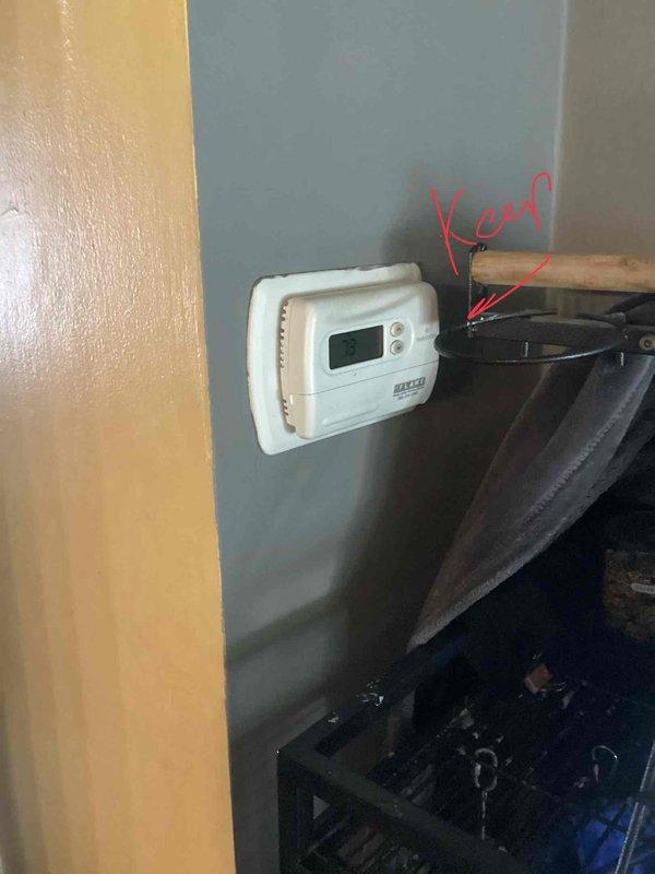 Responded to service call for air conditioning system with non-operational outdoor fan unit. Upon arrival, assessed 2015 AC system with evaporator coil located in basement and outdoor condensing unit mounted at exterior of residence. Conducted diagnostic evaluation to determine cause of fan failure while compressor continued to run. Inspected electrical connections at outdoor unit, noting weathered and rust-compromised meter enclosure and associated conduit requiring attention for proper system operation. Evaluated thermostat functionality and control wiring to rule out low-voltage control issues. Documented existing equipment condition including copper refrigerant line set routing from basement coil location to outdoor unit. Prepared comprehensive replacement estimate for customer consideration given age and condition of existing system components. Photographed current installation including thermostat location, exterior electrical service connections, and outdoor unit positioning for