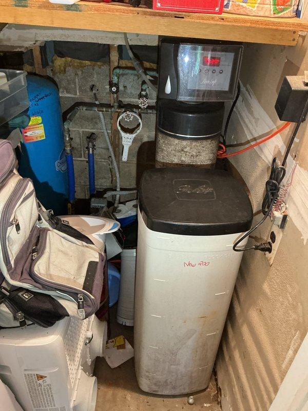 Responded to water leak emergency in basement furnace room affecting hot water supply throughout the building. Upon inspection, identified failed water heater with extensive corrosion, rust staining, and mineral deposit buildup at tank base, along with active leaking and standing water on concrete floor. The unit showed significant deterioration consistent with age-related failure, with visible water damage to the metal base plate and discharge evident around the bottom perimeter. Documented conditions with photographs showing corroded tank base, compromised structural integrity, and water accumulation. The water heater exhibited clear signs of end-of-life failure requiring replacement to restore hot water service and prevent further water damage to the basement area.