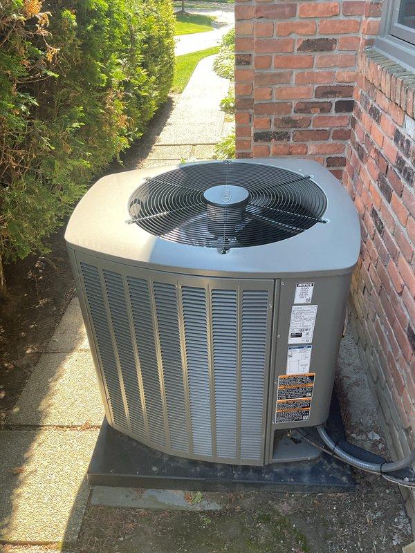 Completed comprehensive Gold AC inspection on residential system less than one year old. Performed full system evaluation including outdoor condenser unit positioned on concrete pad alongside building exterior, verified proper operation of all components, checked refrigerant lines and electrical connections, and inspected air handler/coil assembly located in basement. System found to be operating within normal parameters with no deficiencies noted. Provided MERV 8 filters as requested and documented equipment condition through photographic records showing well-maintained outdoor unit with clean coil surfaces and proper clearances.